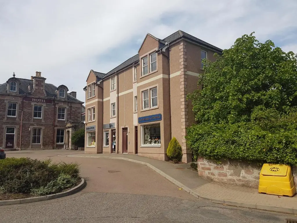 an empty street in front of a building at No.3 On The Square in Beauly