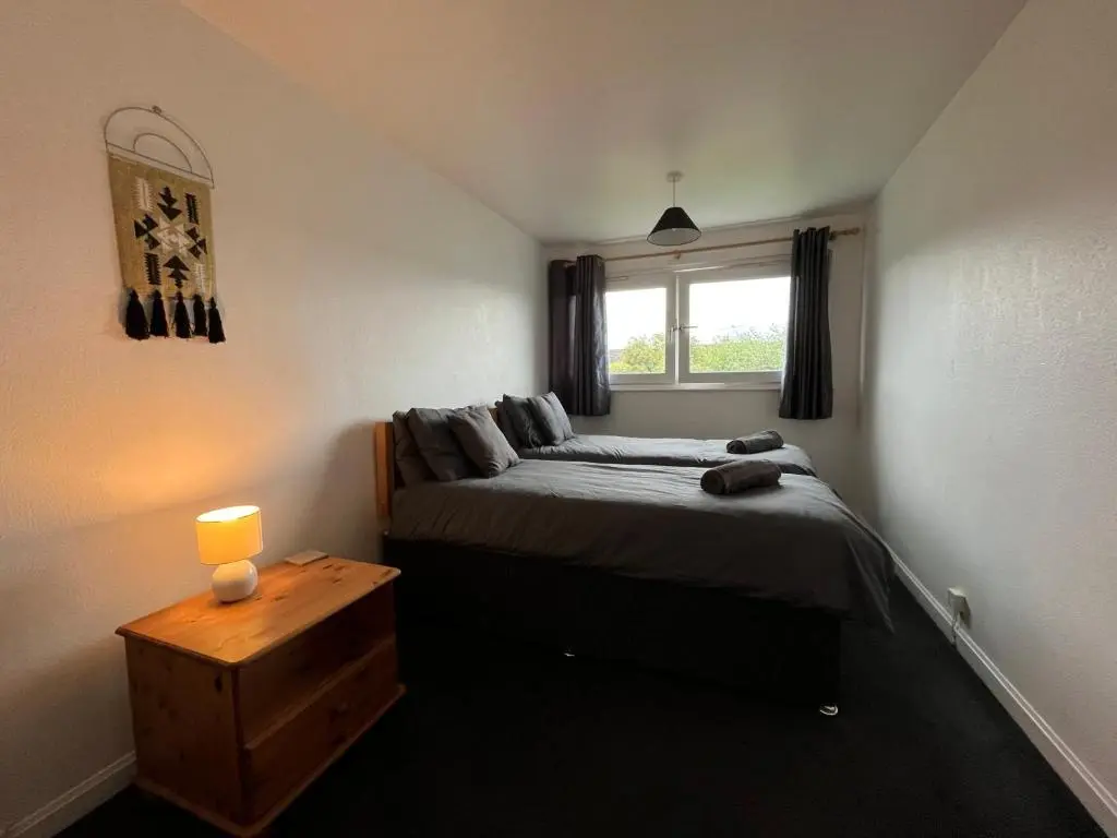 a small bedroom with a bed and a window at Inverness House in Inverness