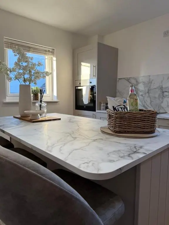 a kitchen with a large marble counter top at Gateway Apartment in Inverness