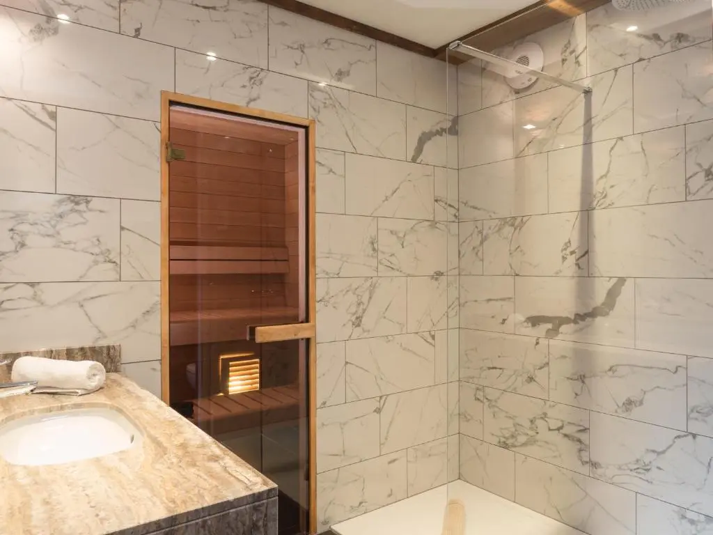 a bathroom with a sink and a shower at Cairngorm Lodge in Aviemore