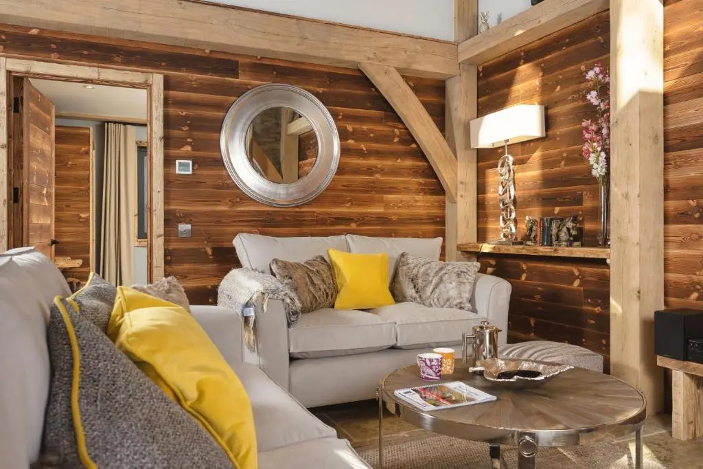 a living room with a couch and a table at Cairngorm Lodge in Aviemore