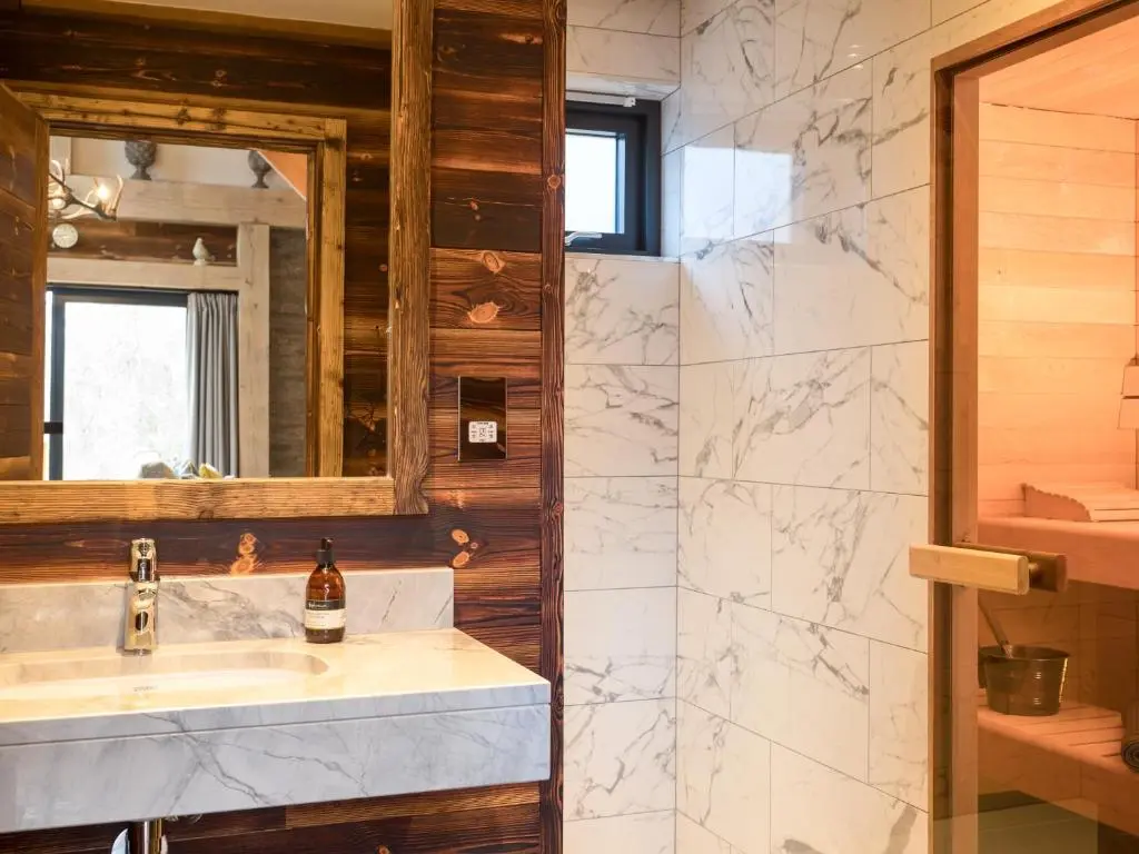 a bathroom with a sink and a mirror at Macdui Lodge in Aviemore