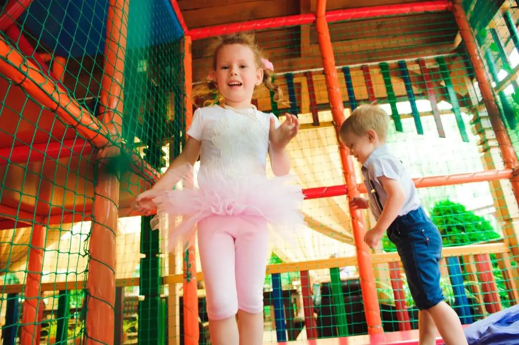 a little girl and a boy playing on a playground at Macdonald Aviemore Hotel at Macdonald Aviemore Resort in Aviemore