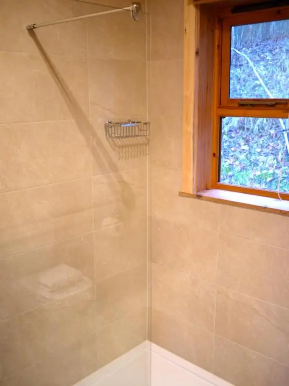 a shower with a glass door in a bathroom at Dulnain in Aviemore