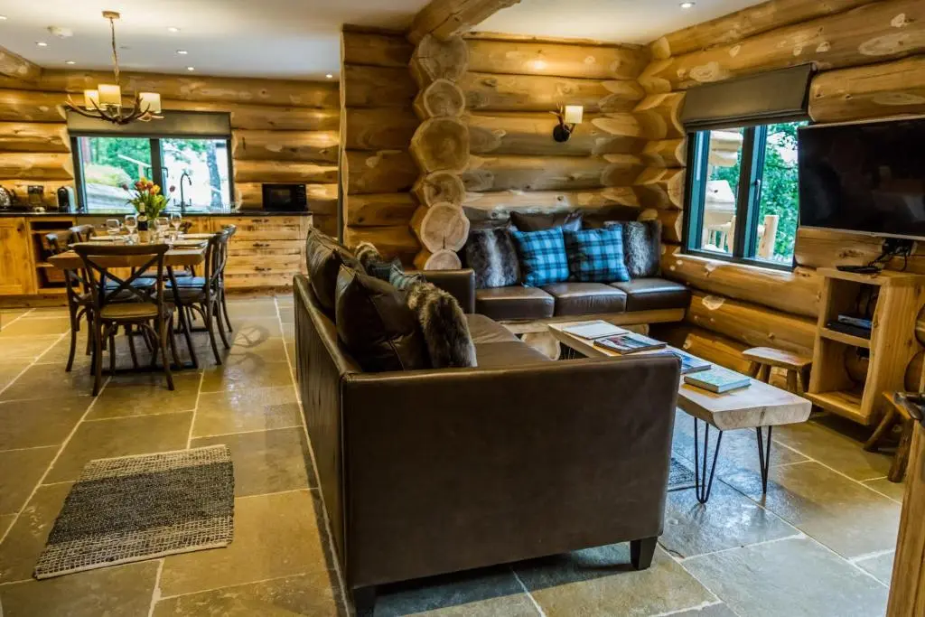 a living room with a couch and a table at Cedar Lodge in Aviemore