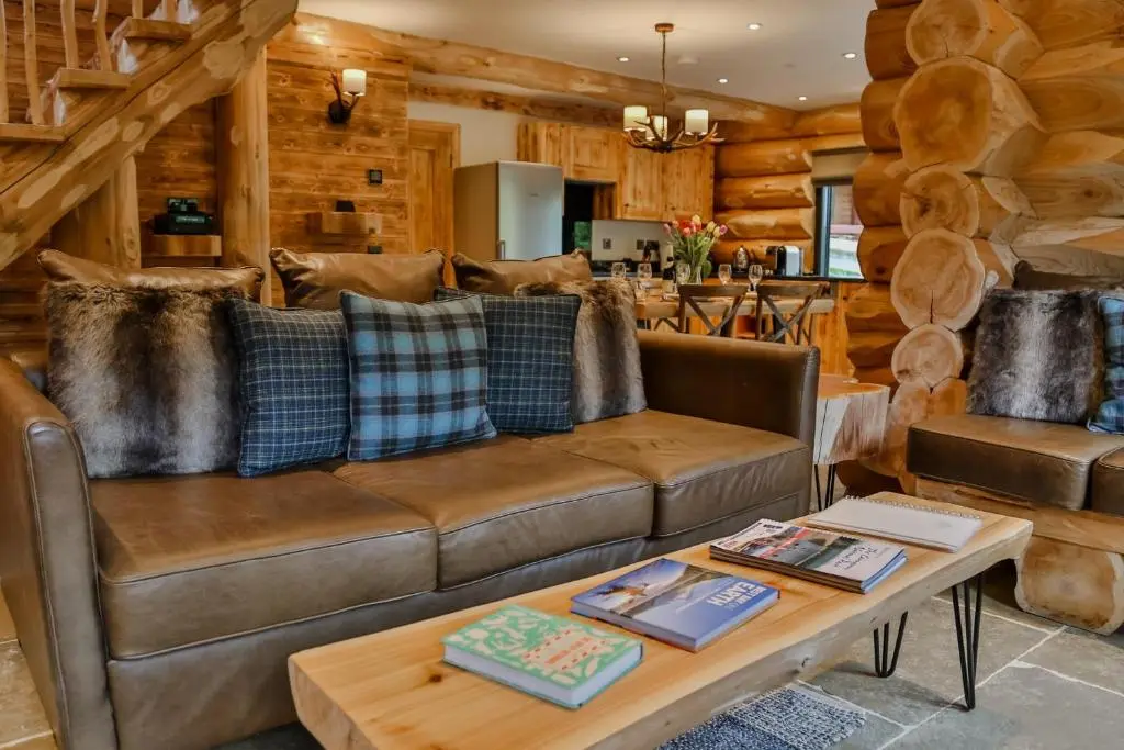 a living room with a couch and a table at Cedar Lodge in Aviemore