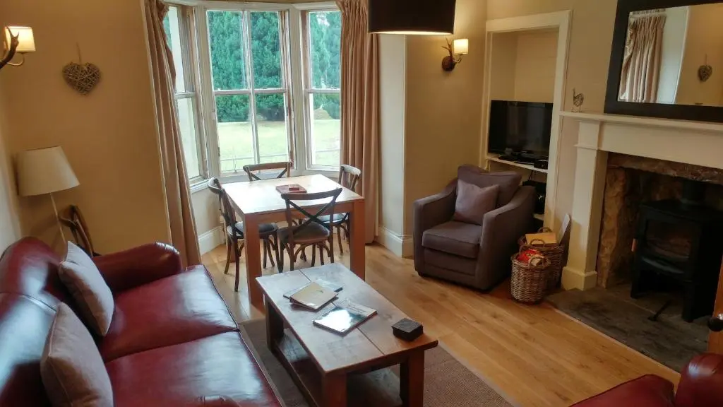 a living room with a couch and a table at Shieling in Aviemore