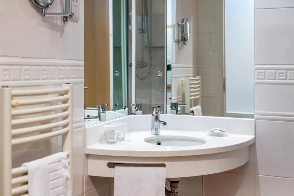 a bathroom with a sink and a mirror at High Range Lodge Hotel in Aviemore