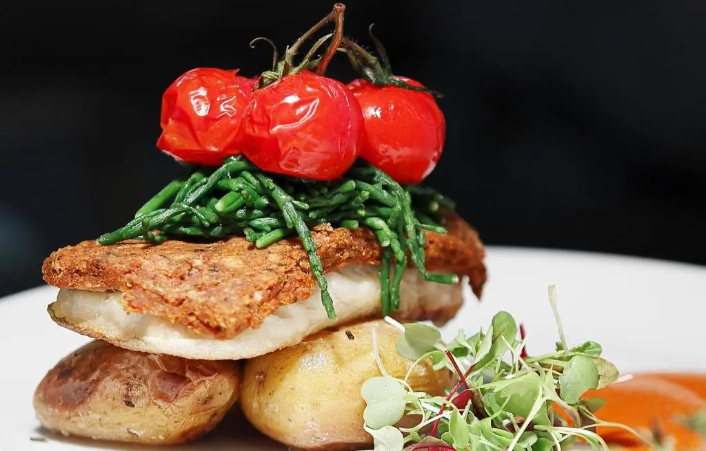 a sandwich with tomatoes on top of it on a plate at Invergarry Hotel in Invergarry