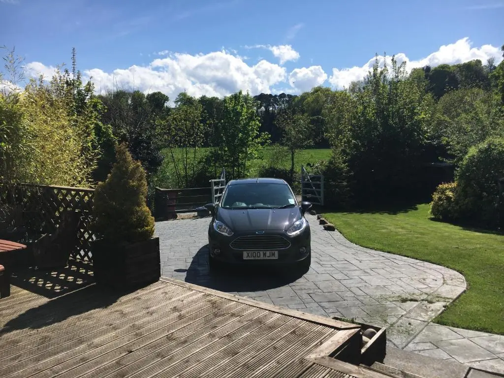 a car parked in the driveway of a house at Old Mills Garden in Elgin