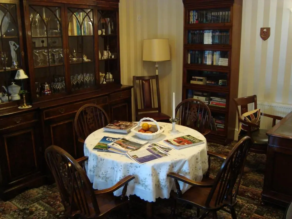 a dining room with a table with a bowl of fruit on it at Willowbank in Grantown on Spey