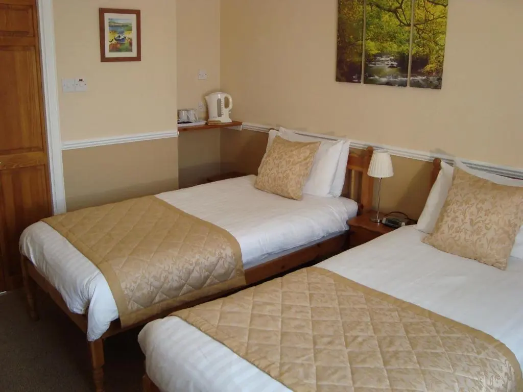 a hotel room with two beds in a room at Willowbank in Grantown on Spey