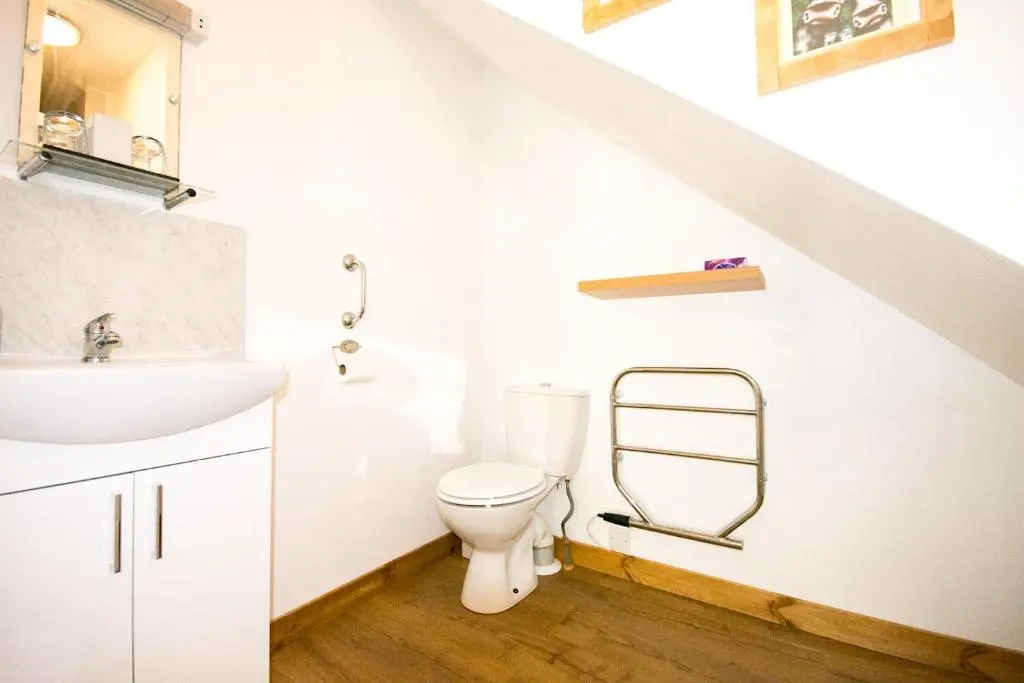 a bathroom with a white toilet and a sink at Craik Na Dav B&B in Invermoriston