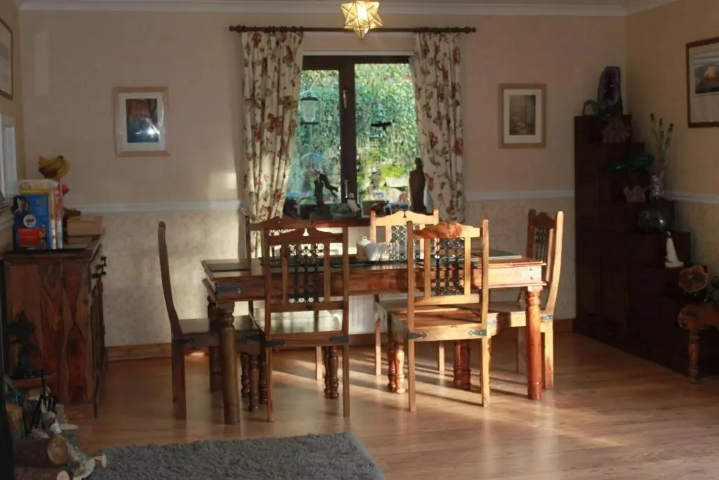 a dining room with a wooden table and chairs at Craik Na Dav B&B in Invermoriston