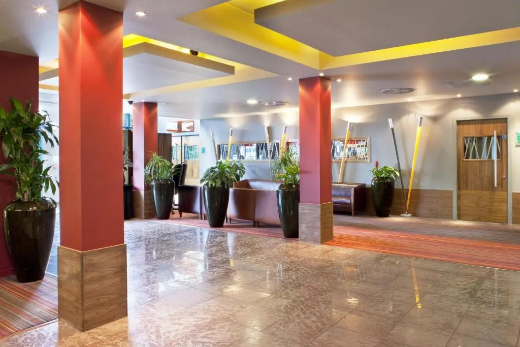 a lobby of a hotel with potted plants at Holiday Inn Aberdeen West by IHG in Westhill