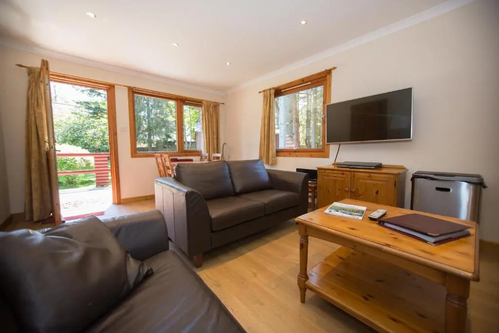 a living room with a couch and a table at Invercauld Lodges in Ballater