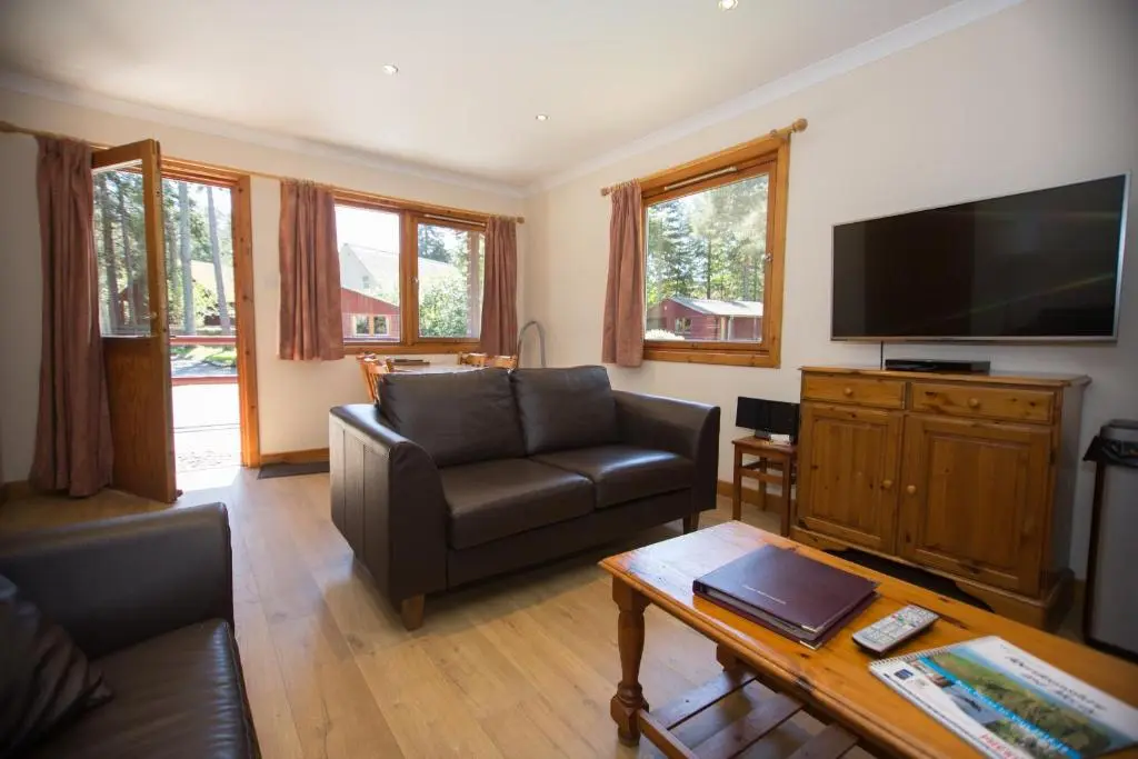a living room with a couch and a television at Invercauld Lodges in Ballater