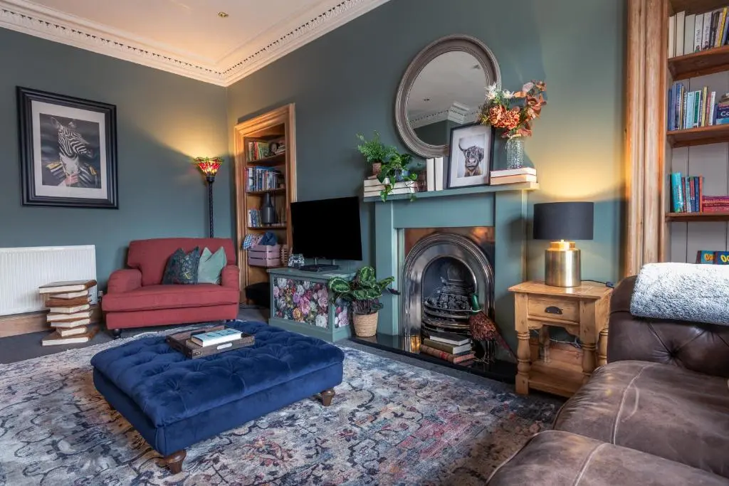 a living room with a couch and a fireplace at The Nessting Place in Inverness