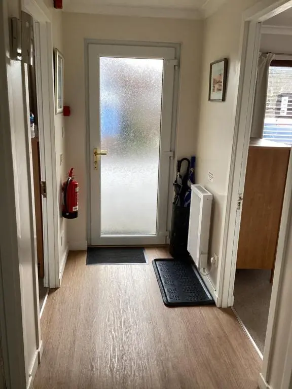 a hallway with a door leading to a room at Furan GuestHouse in Inverness