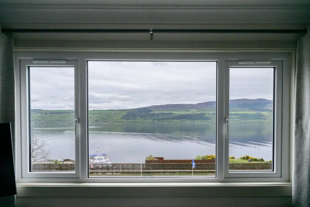 a window with a view of a body of water at Loch Ness Clansman Hotel in Drumnadrochit