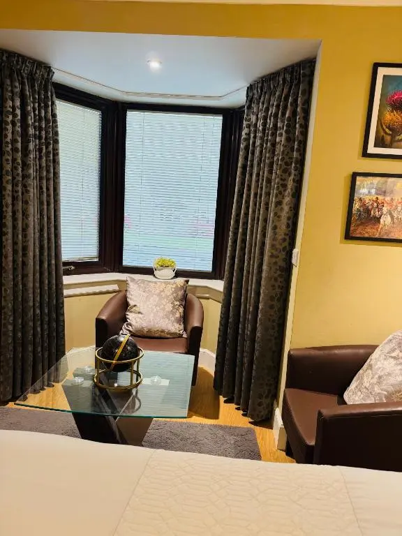 a living room with a couch and a glass table at The Milton Accommodation in Elgin