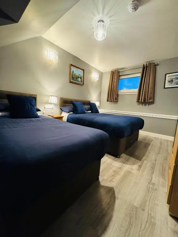 a bedroom with two beds in a room at The Milton Accommodation in Elgin