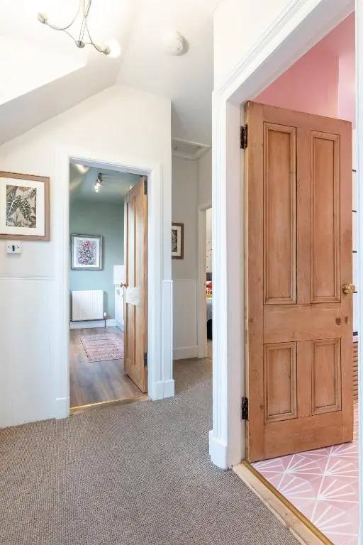 a hallway with a door and a mirror at Taigh Carnan in Inverness