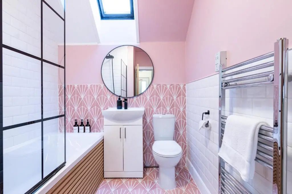 a bathroom with a toilet and a mirror at Taigh Carnan in Inverness