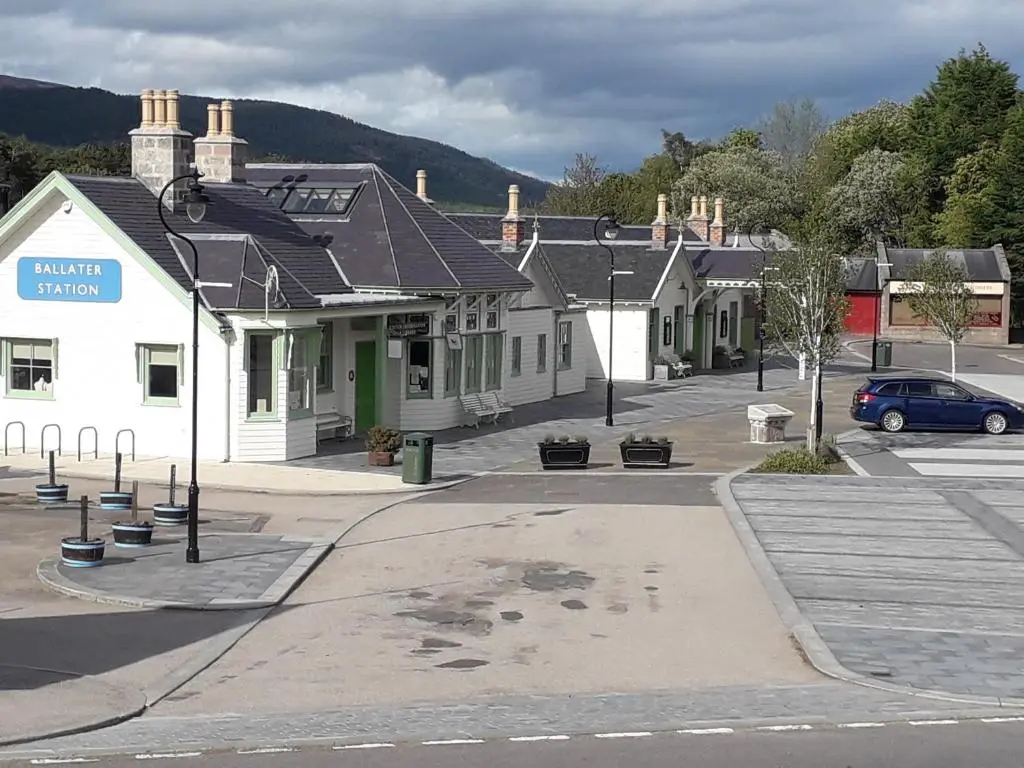 a town with a car parked in a parking lot at Celicall in Ballater