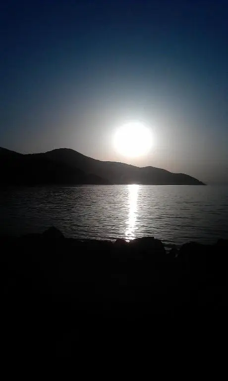 a sun setting over a body of water at Kindale House in Helmsdale