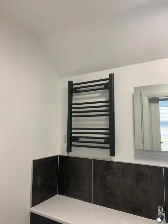 a bathroom with a mirror and a sink at Eastdene Guest House in Inverness