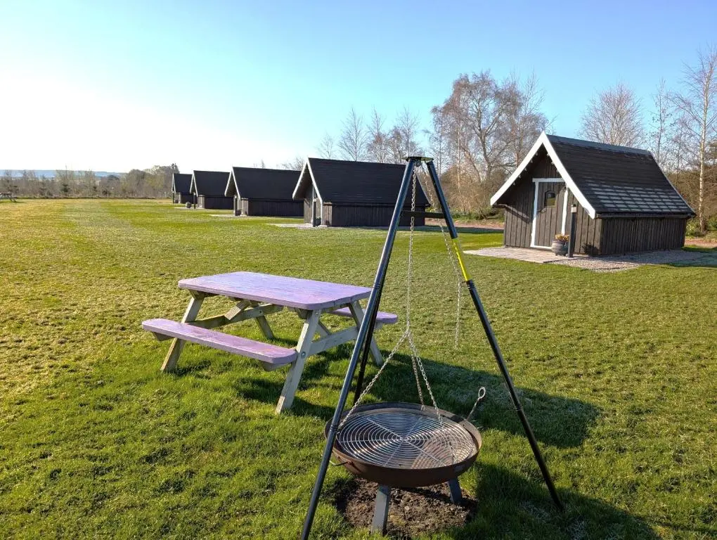 a picnic table and a grill in a field at Macbeth's Hillock in Forres