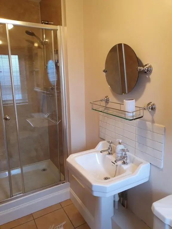 a bathroom with a sink and a shower at Clachan Farmhouse B & B in Ullapool