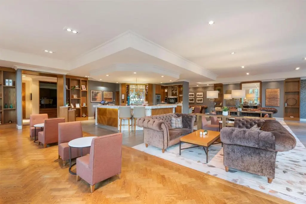 a large living room with couches and a bar at Hilton Grand Vacations Club Craigendarroch Suites Scotland in Ballater