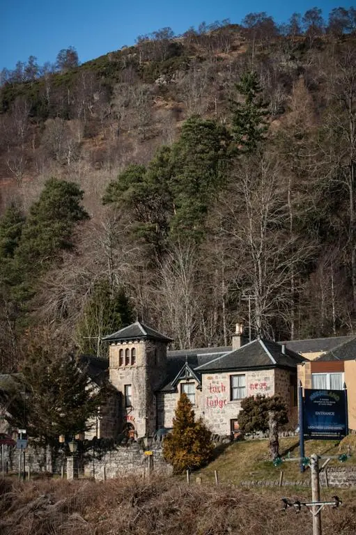 an old house on the side of a hill at Loch Ness Lodge Hotel in Drumnadrochit