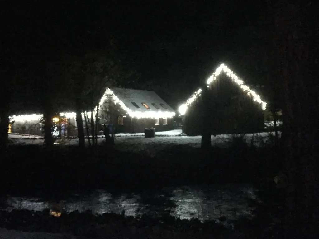 a barn lit up at night with lights on it at Coylumbridge Cottage in Aviemore
