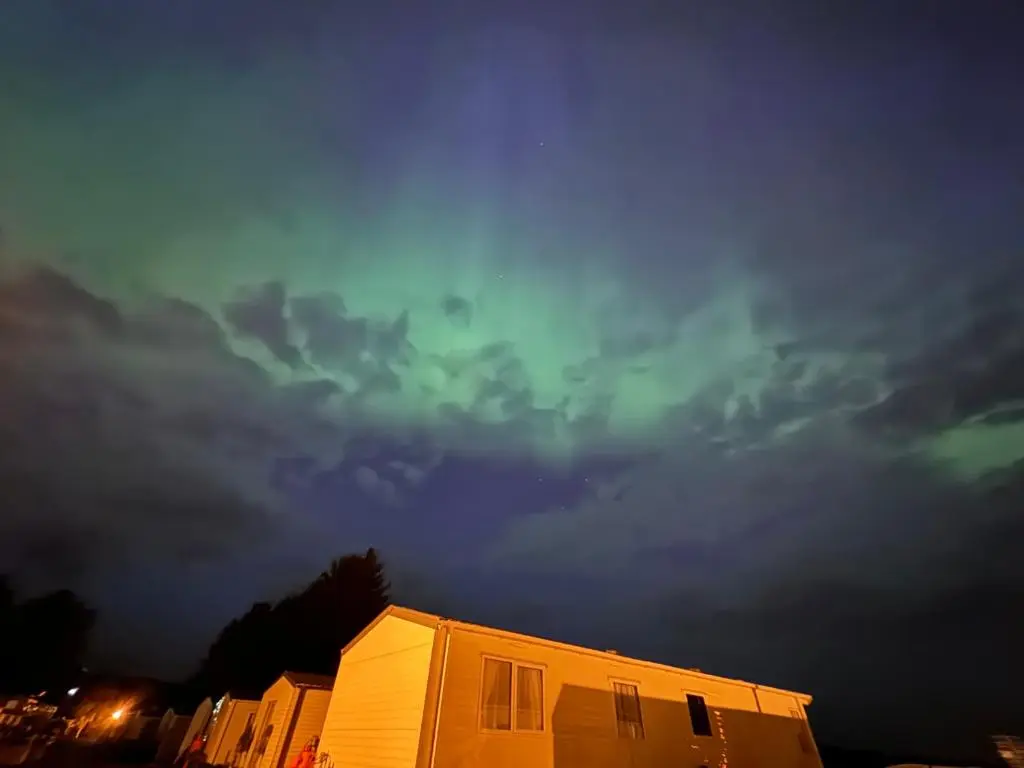 a building under a cloudy sky at night at Poppy Lodge in Boat of Garten