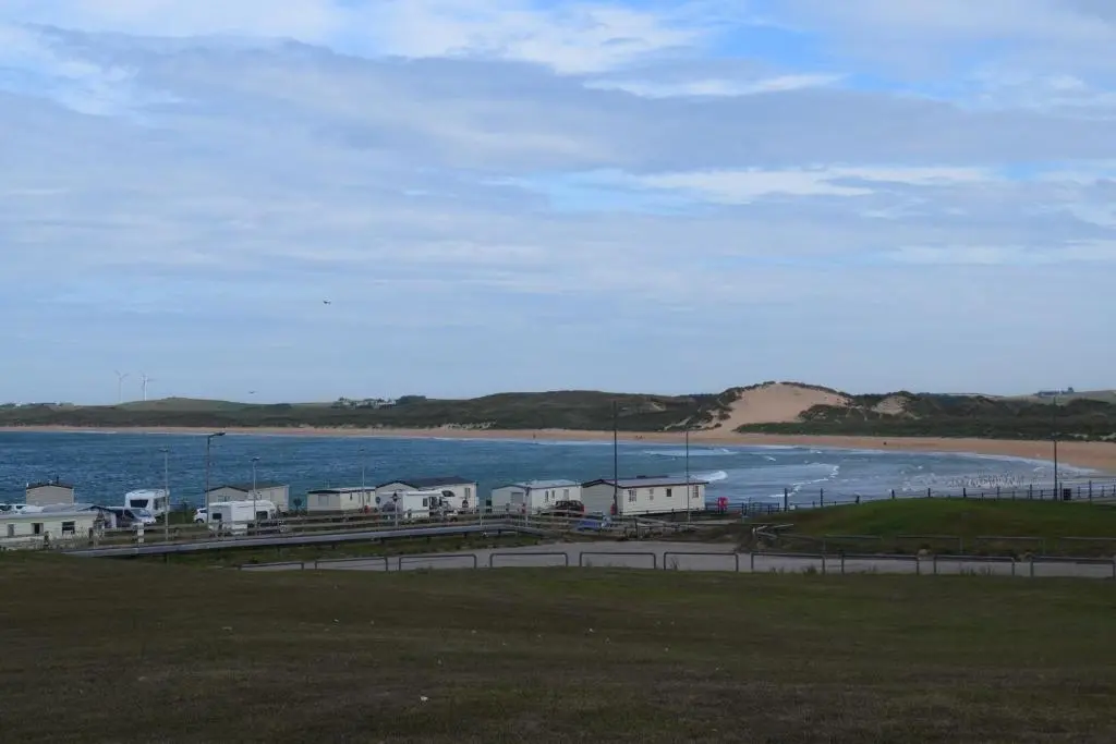 a view of a beach with houses and the ocean at Cheers Cafe Bar & Tavern in Fraserburgh