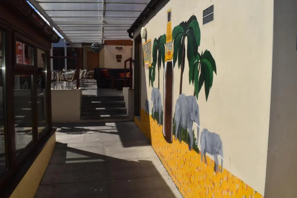 a building with a painting of animals on the side of it at Cheers Cafe Bar & Tavern in Fraserburgh