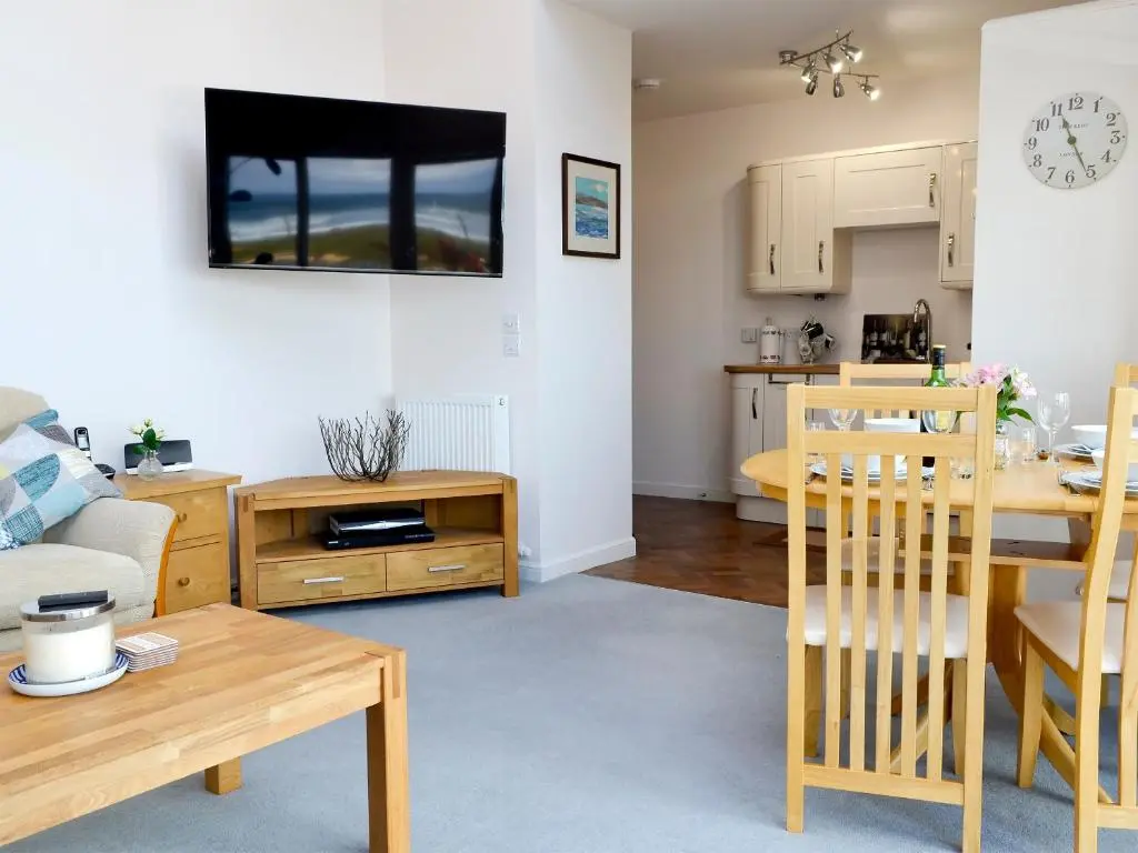 a living room and kitchen with a table and a dining room at Seascape in Whitehills