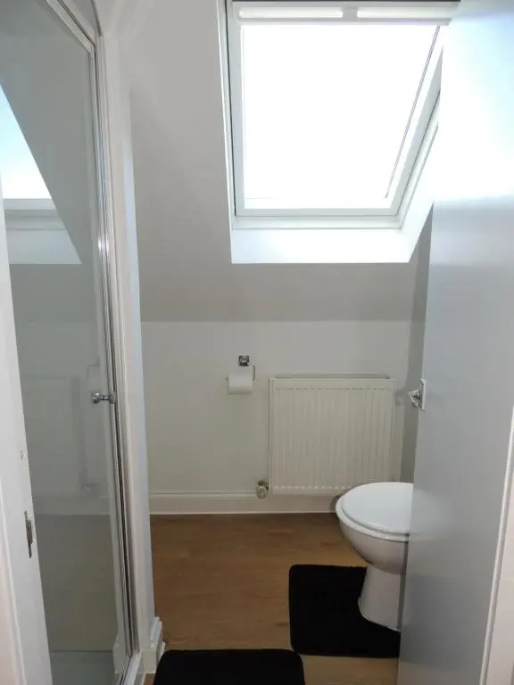 a bathroom with a toilet and a window at 5A Union Road in Macduff