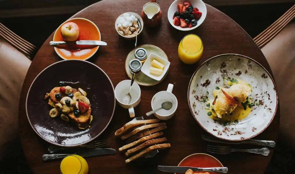 a wooden table with plates of food on it at Banchory Lodge Hotel in Banchory