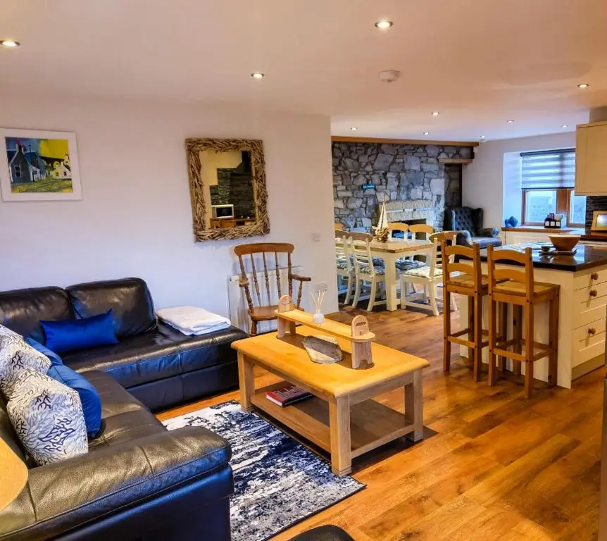 a living room with a couch and a table at Cullen 117 Seatown With Sea Views in Cullen