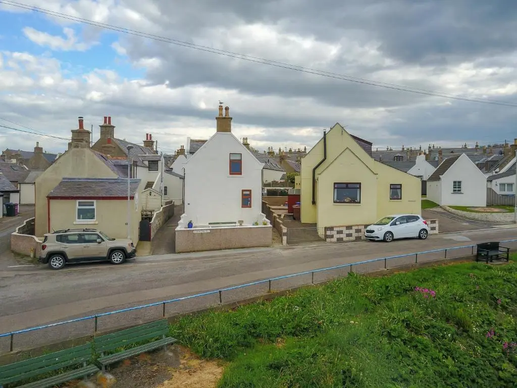 a group of houses and cars parked on a street at Portknockie 17 Harbour Place in Portknockie
