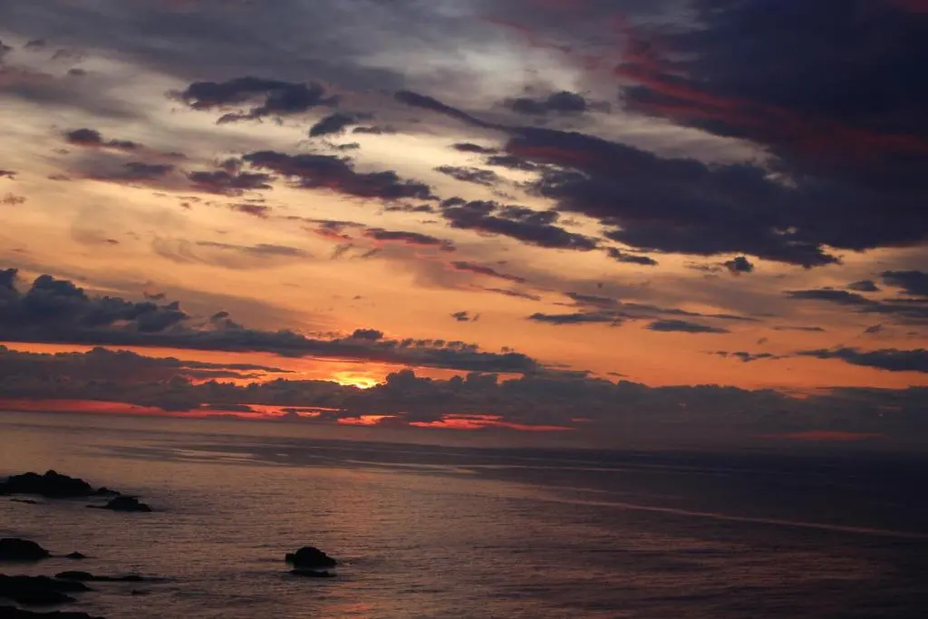 a sunset over the ocean with a cloudy sky at Portknockie 17 Harbour Place in Portknockie