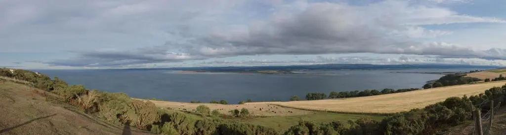 a view of a large body of water under a cloudy sky at Dolphin View Hillockhead in Rosemarkie