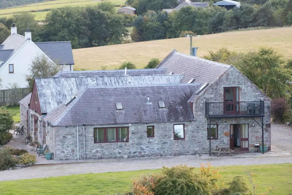 an aerial view of a stone house with a balcony at Dolphin View Hillockhead in Rosemarkie