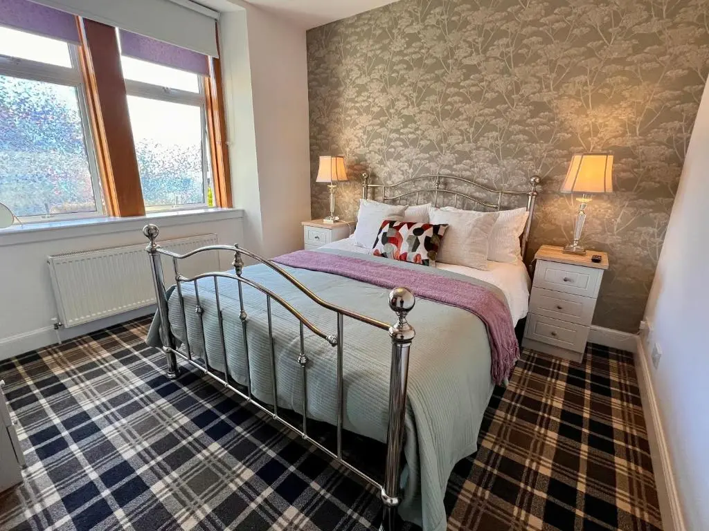 a bedroom with a bed and a wall mural at The Stags Head Apartment in Inverness