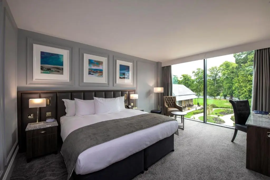 a bedroom with a large bed and a large window at Ness Walk in Inverness