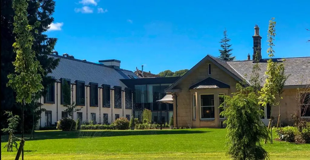 an exterior view of a building with a lawn at Ness Walk in Inverness